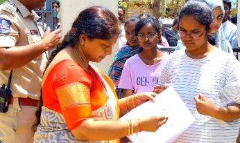 an official checking documents of a NEET aspirant